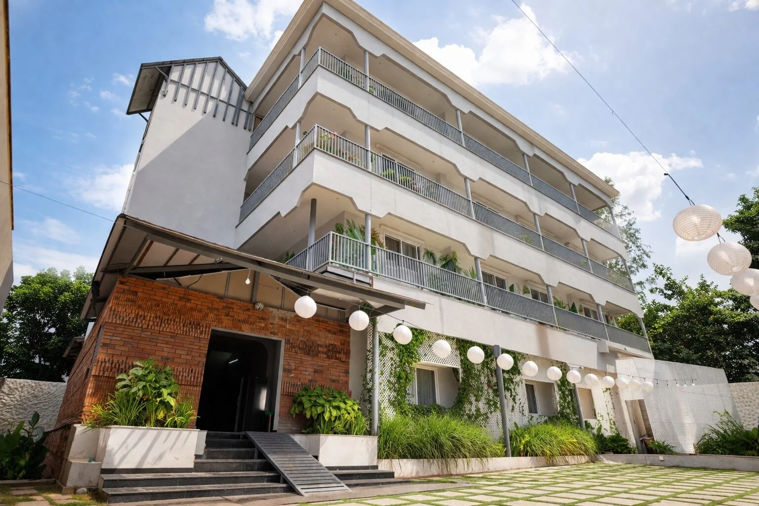Pool-facing accommodation balconies above the courtyard and paper lanterns