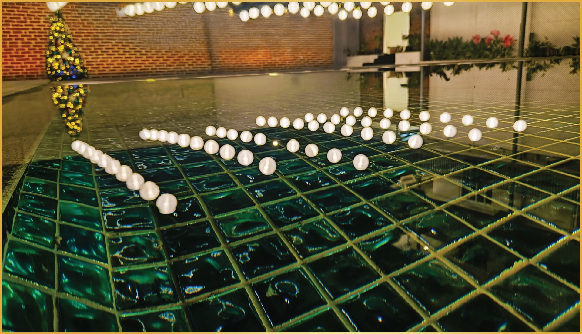 The swimming pool with floating lights in the evening