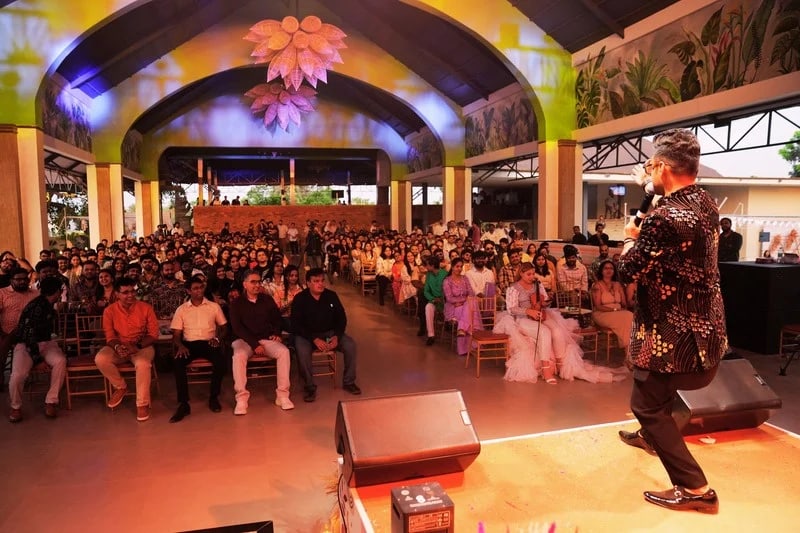 A speaker addressing a seated audience inside Padma Pavilion
