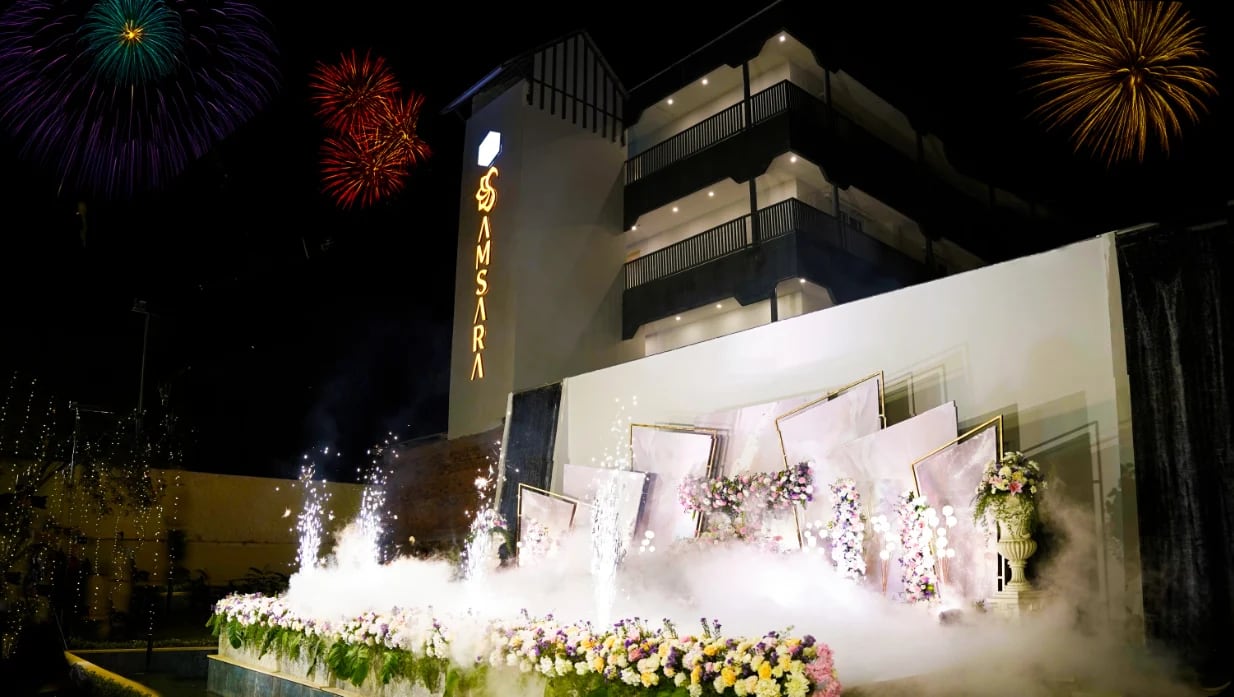 A reception stage beside the Samsara building, with fireworks overhead