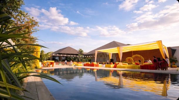 Yellow décor beside the swimming pool for a daytime function