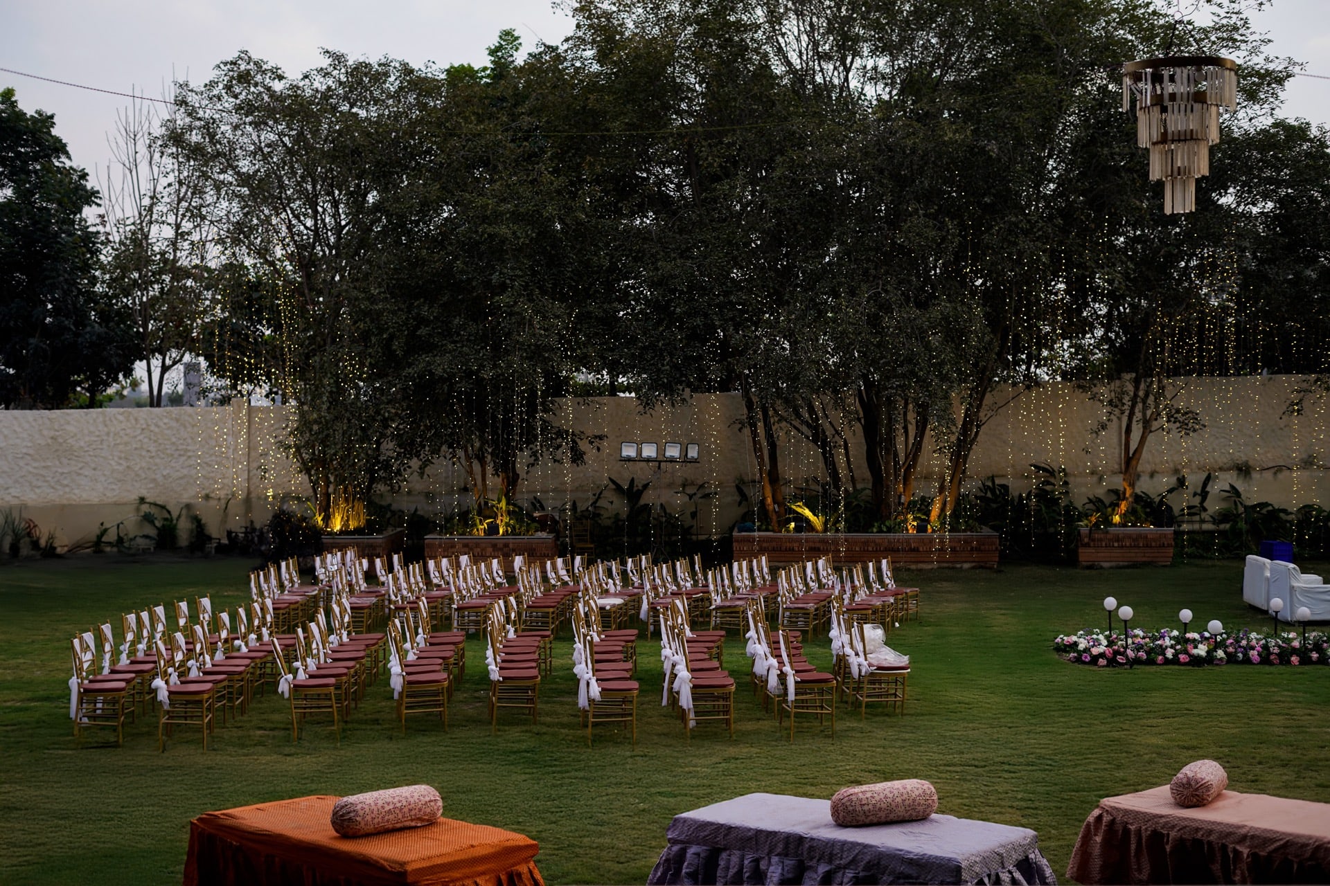 Padma Lawns under the trees and fairy lights at dusk