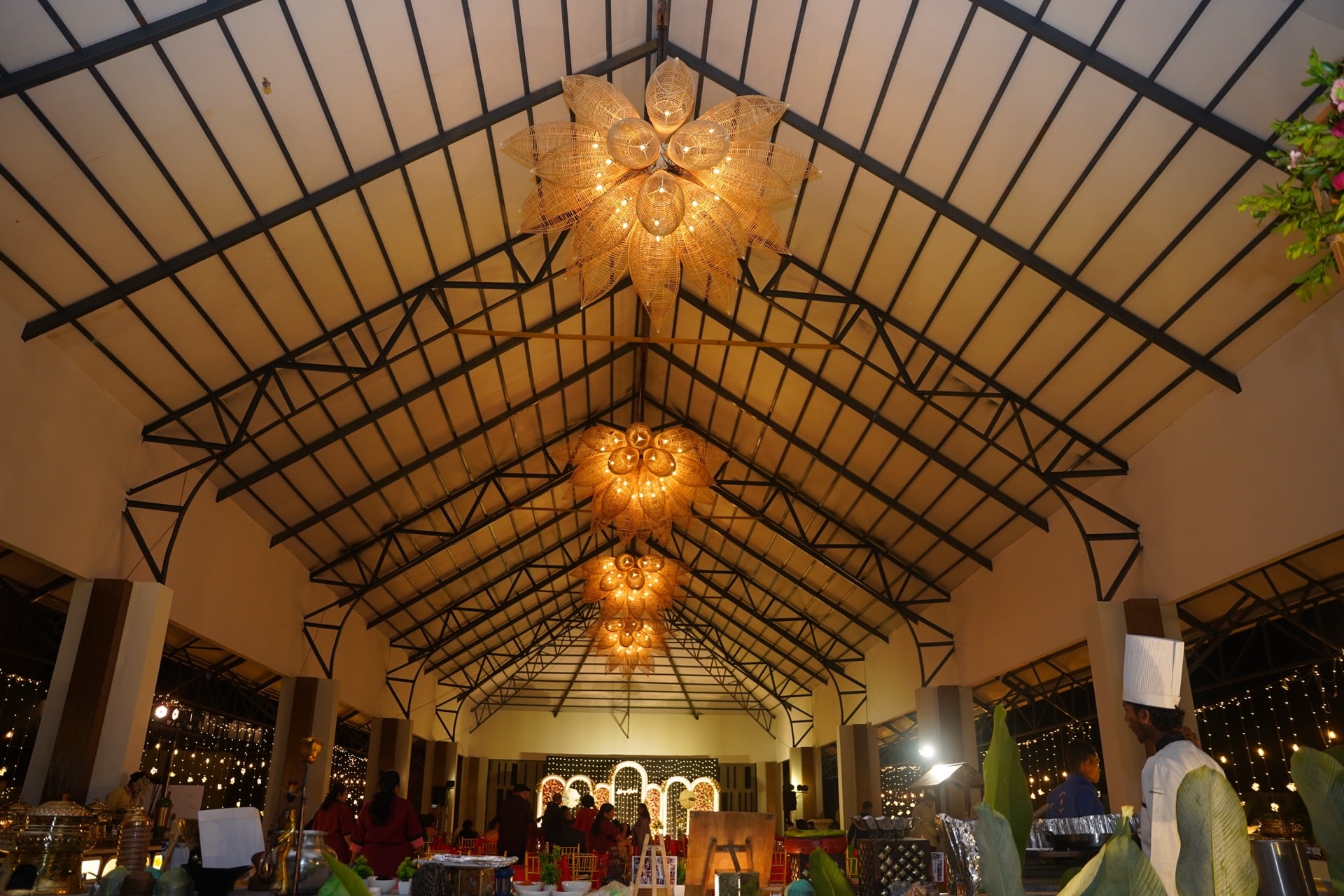The pavilion’s vaulted ceiling and woven lotus chandeliers