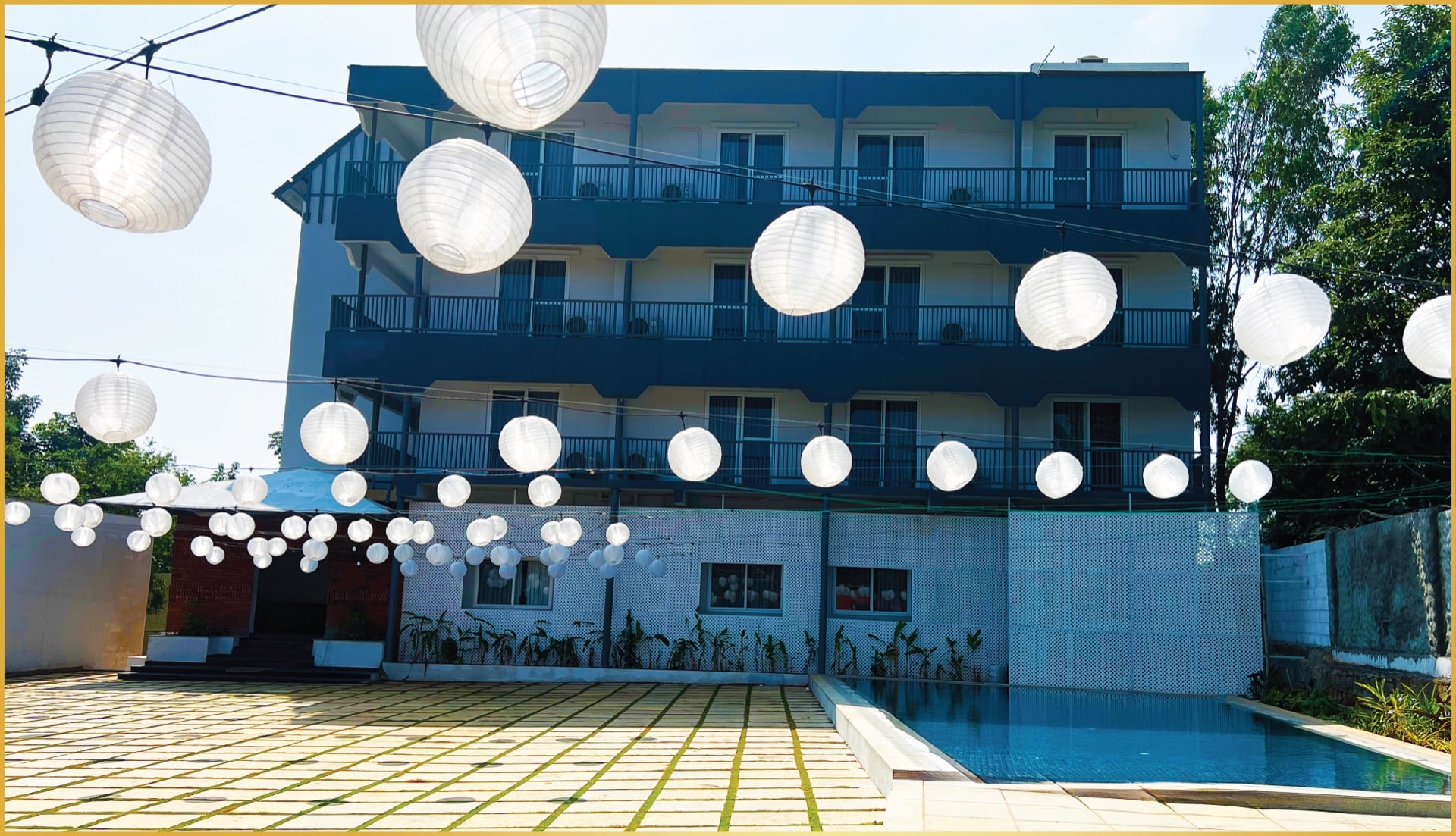 Paper lanterns strung over the pool for an evening reception