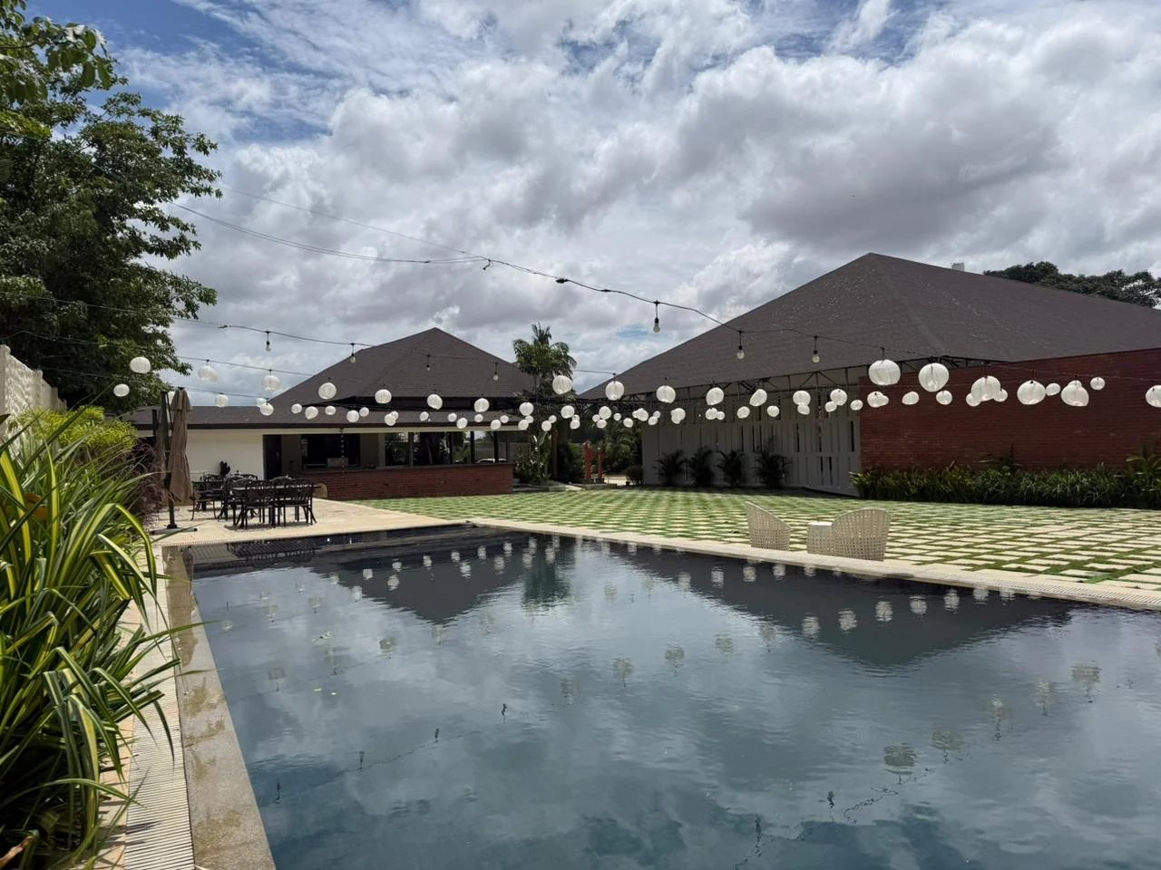 The swimming pool reflecting the sky beside Aavya Poolside Court