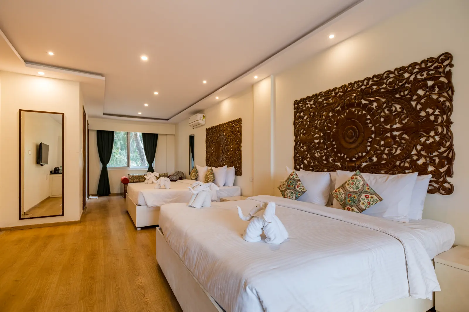 A Rahayu Suite with king bed, carved headboard and seating