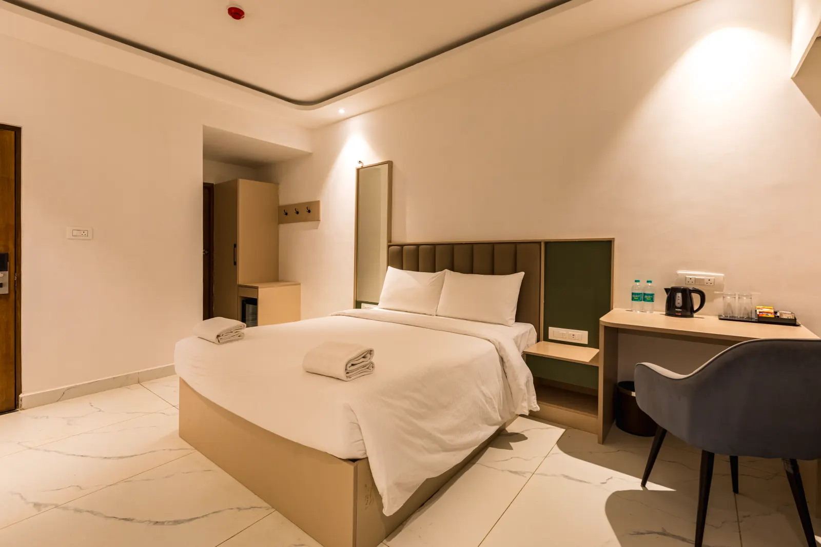 An Aanya Residence with upholstered headboard and writing desk