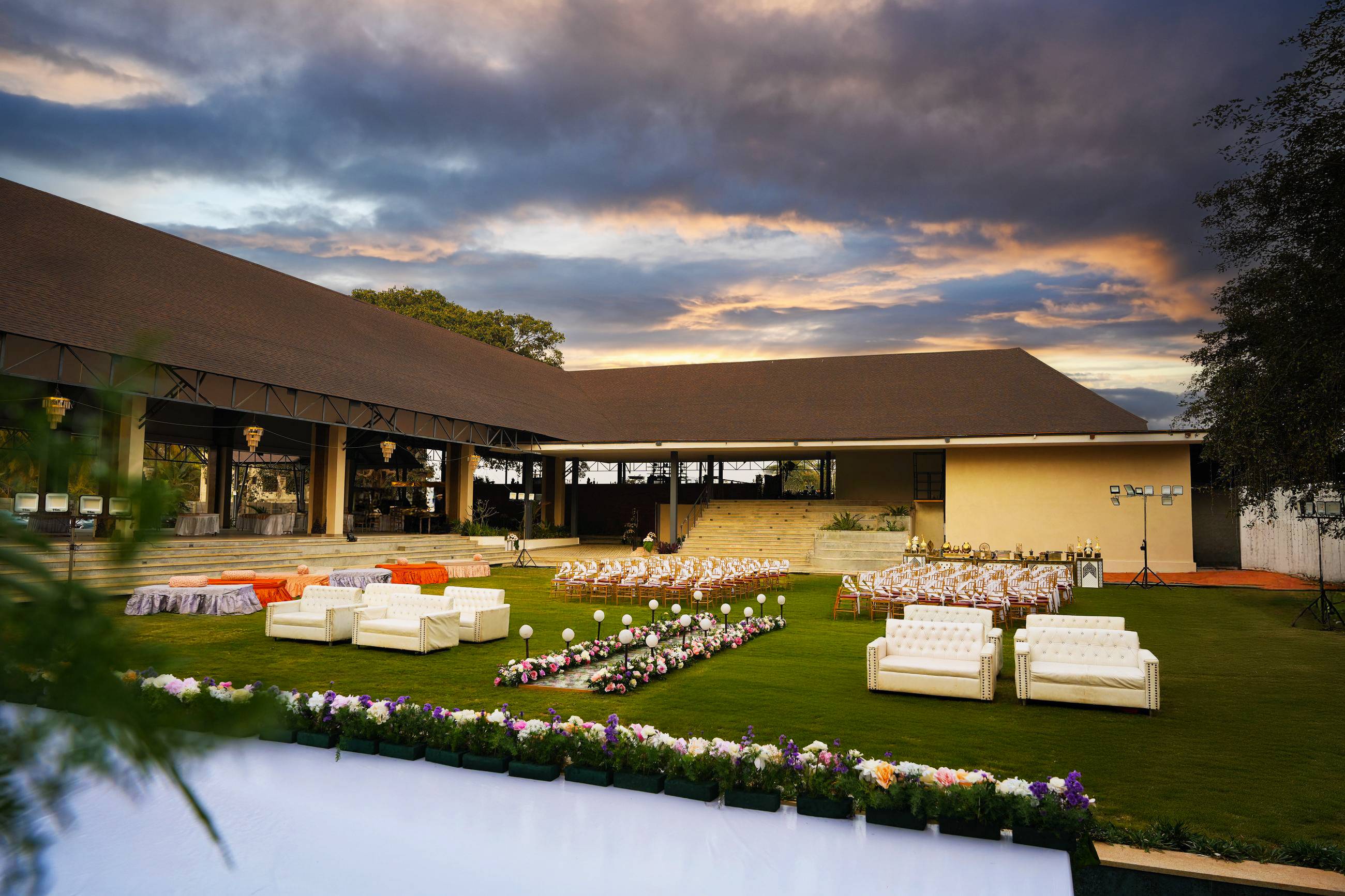 Padma Pavilion and the lawn at dusk, seen across the water