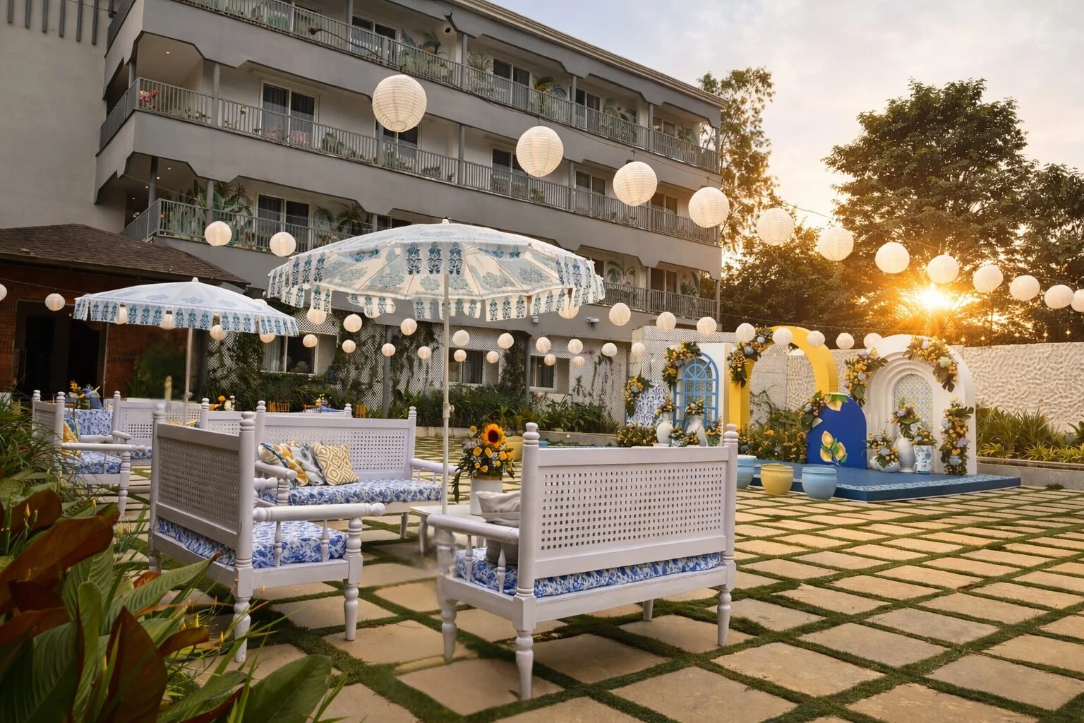 Aavya Poolside Court set for a celebration with white lounge seating and paper lanterns